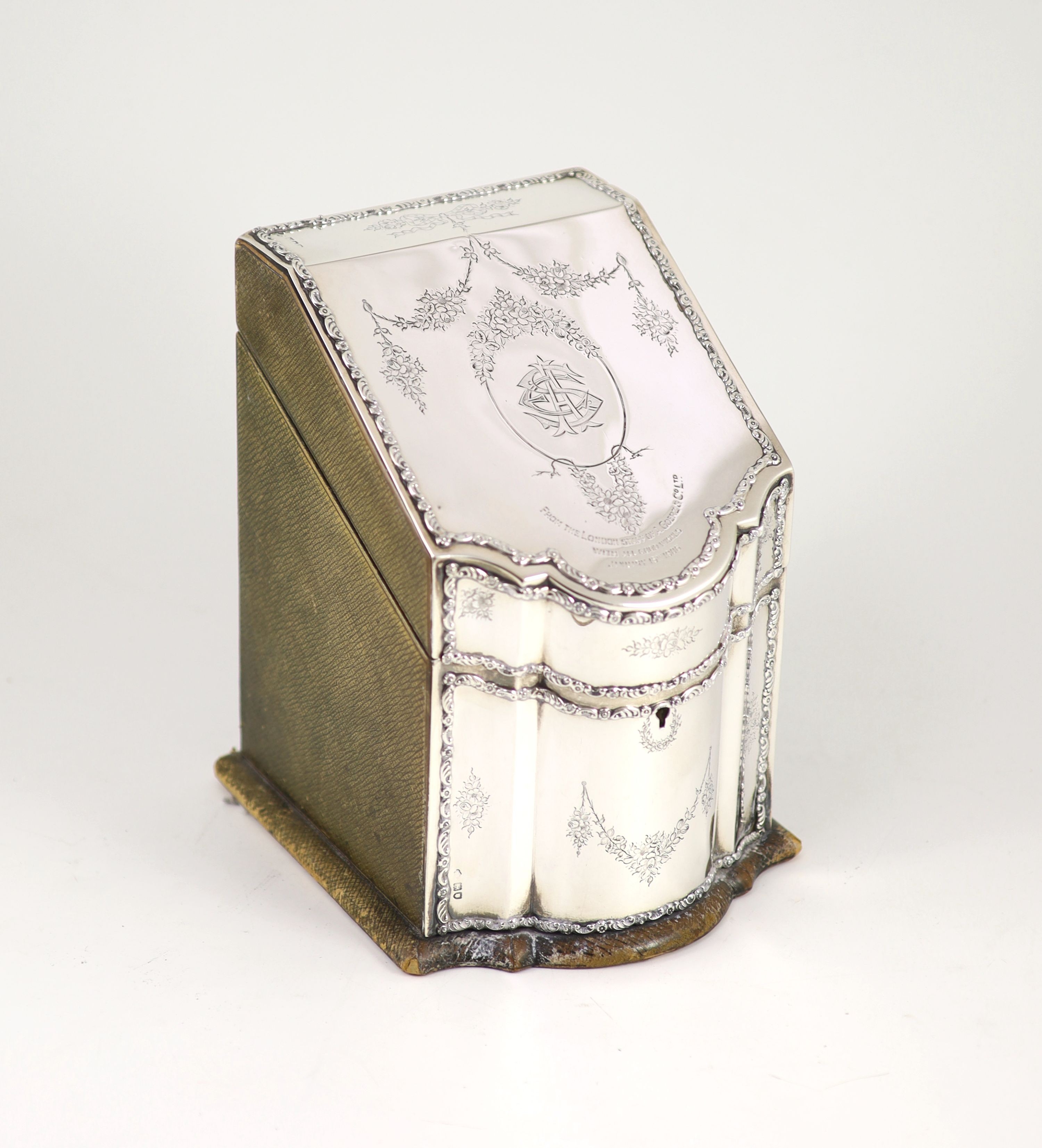 An Edwardian silver mounted leather three piece desk set, comprising a stationary box in the form of a knife box, paperweight and blotter